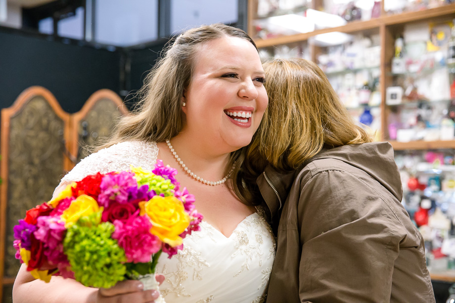 bride giving mom a warm hug before doing her first look with the groom