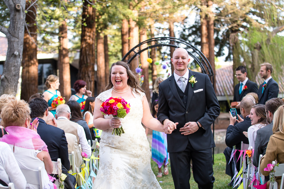 newlyweds walking down the aisle as a couple