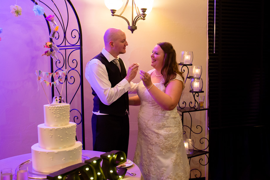 bride and groom feeding each other cake