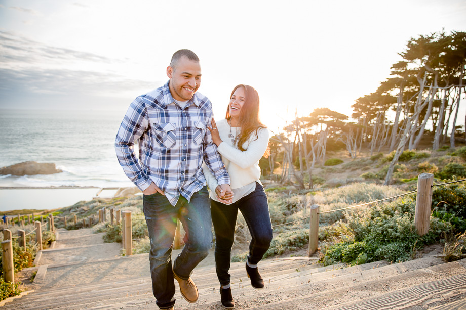 candid sunflare engagement photo at sutro baths