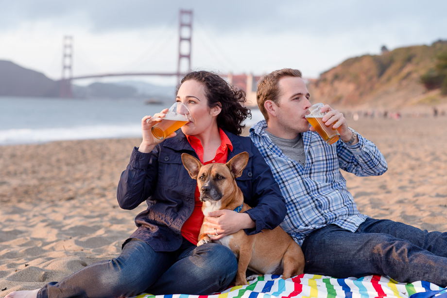 engaged couple chugging craft beer on Baker Beach