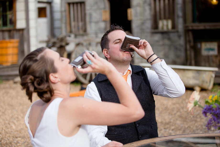 bride and groom shooting whiskey at their reception