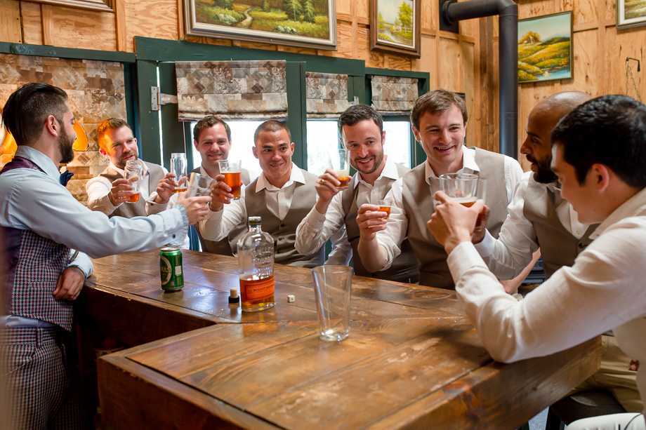 groomsmen and groom drinking before the ceremony