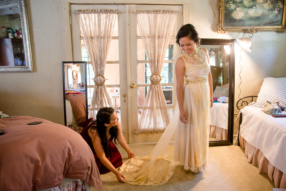 a beautiful wedding dress with a lace train with Vietnamese accents