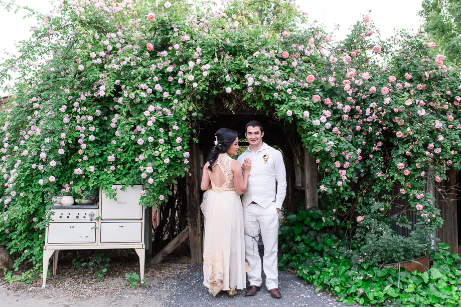bride and groom standing under the flower tunnel at Union Hill Inn, Sonora