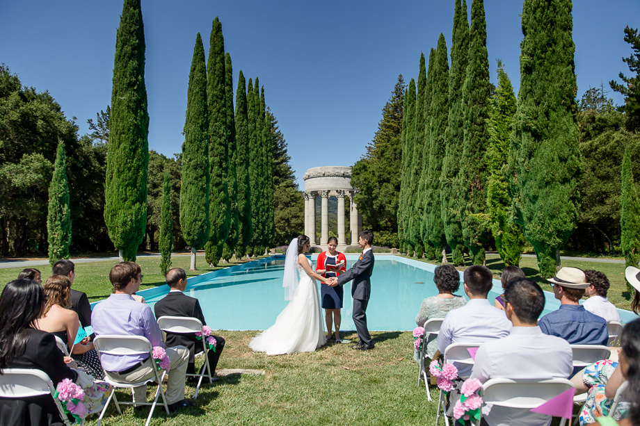 a beautiful wedding ceremony in front of the pulgas water temple