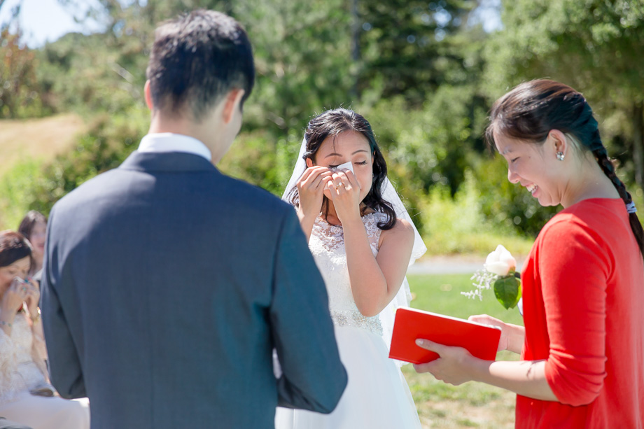 bride wiping away her happy tears at ceremony