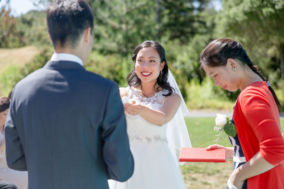 bride passing her tissue to the groom at the ceremony - cute moment