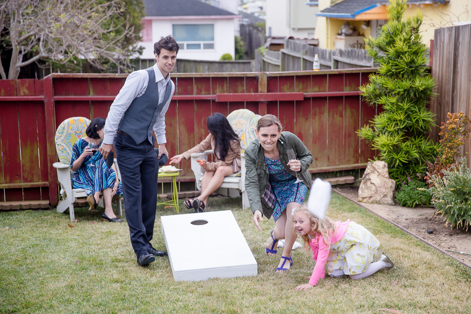 wedding guests having fun with cornhole lawn game