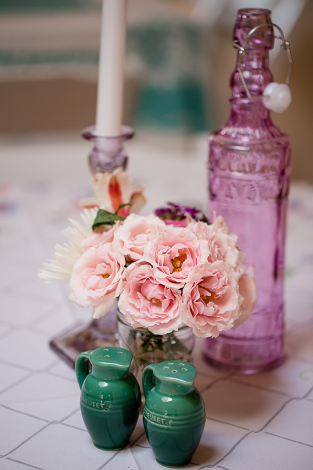 floral centerpiece with vintage bottle and candle