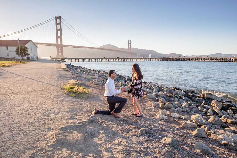 a romantic Crissy Field surprise engagement proposal with Golden Gate Bridge as the backgraound