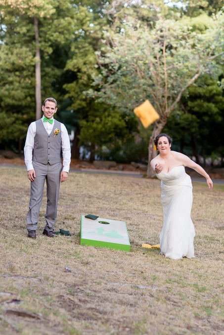 newlyweds having fun with lawn games during their wedding reception