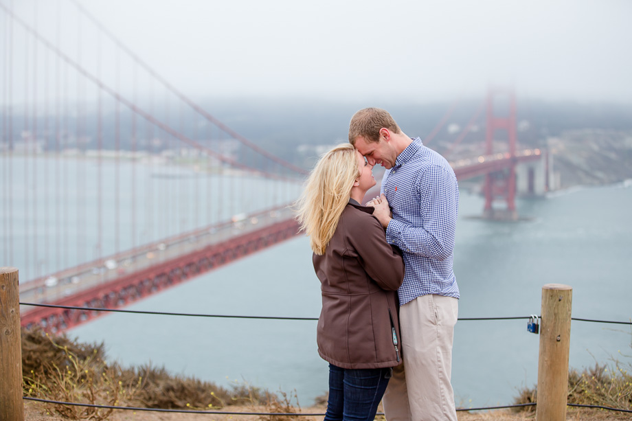 engagement photo looking at foggy golden gate bridge