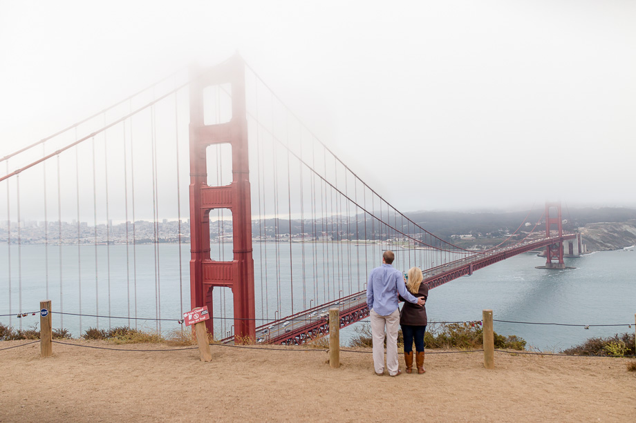 romantic photo in front of golden gate bridge with a little fog