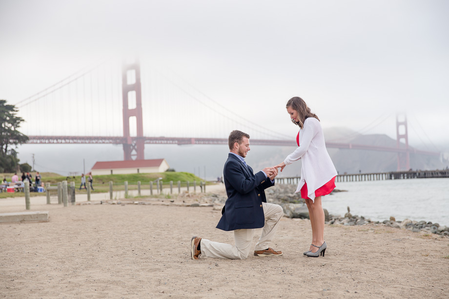 A San Francisco surprise engagement proposal at Crissy Field, with foggy Golden Gate Bridge in the background