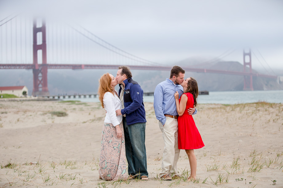 a romantic family photo in front of the Golden Gate Bridge after a surprise engagement proposal