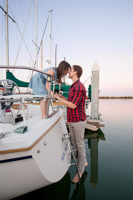 a romantic kiss on the water - Bay Area sailboat sunset engagement picture