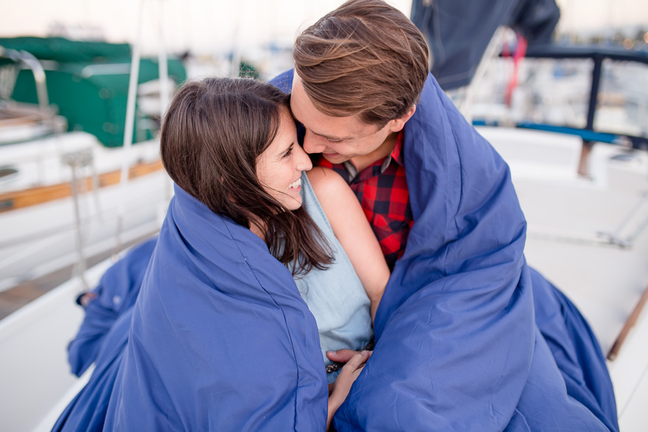 a sweet hug on their sailboat - San Mateo engagement photo