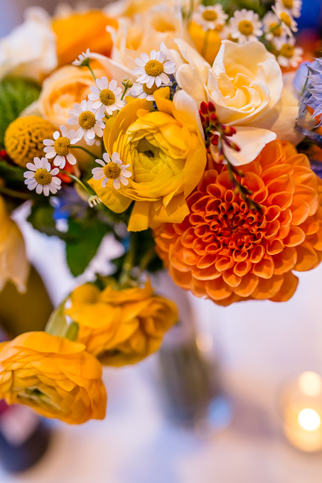 yellow and orange floral centerpiece for navy blue and yelow wedding