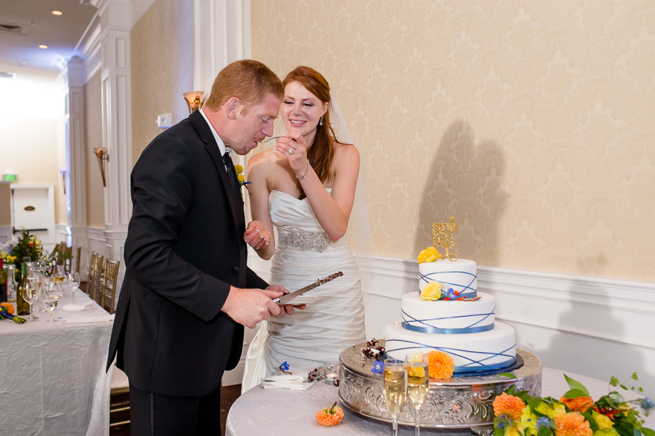 bride feeds the groom cake