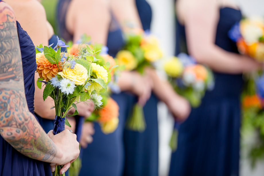 yellow and orange bridesmaid bouquets and navy blue bridesmaid dresses