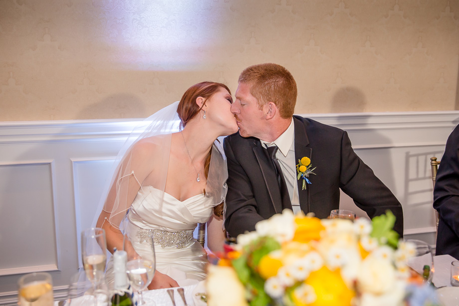 newlywed kissing during reception