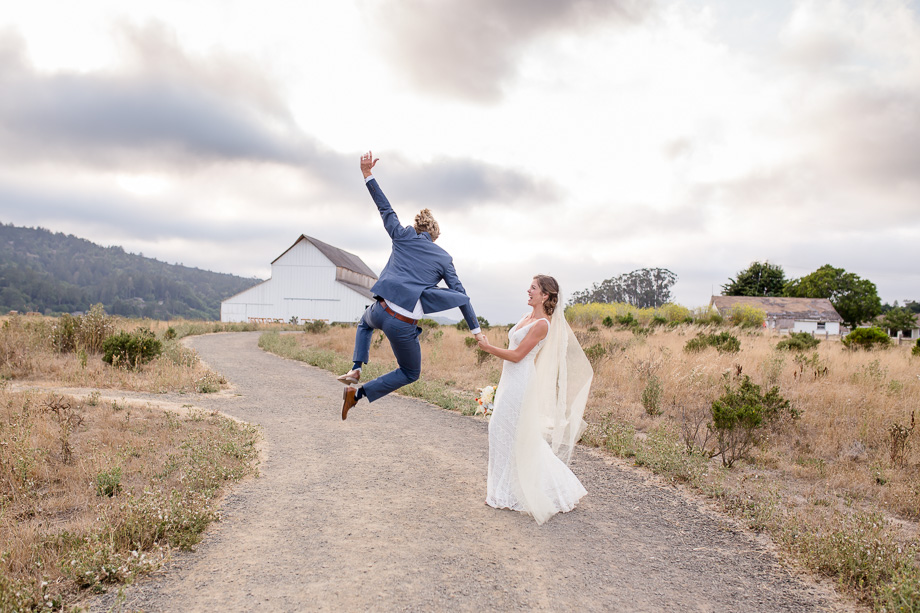 ecstatic groom kicking in the air - San Francisco photojournalistic wedding photographer