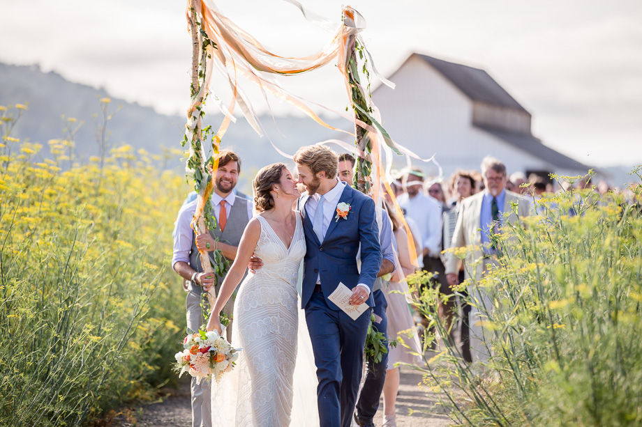 romantic wedding parade in a yellow wildflower field - Point Reyes Station wedding photographer