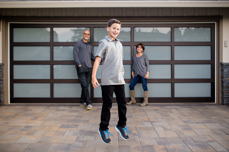 boy jumping in front of parents