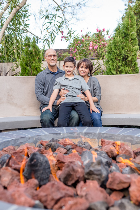 mother father son family photo in front of fire pit