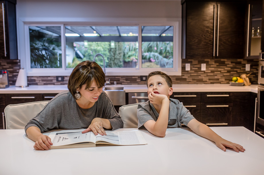 son looking bored of mom teaching him things