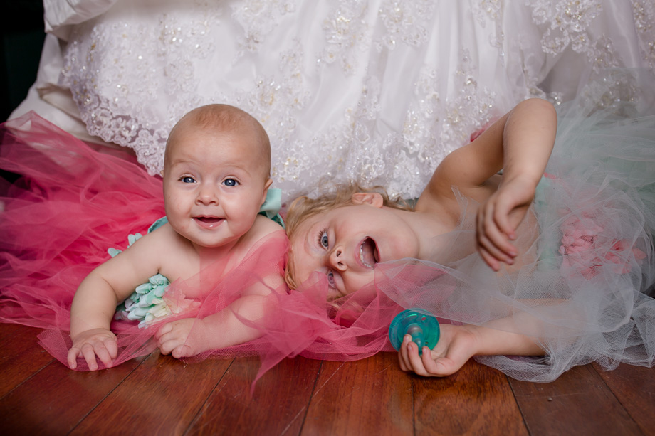 brides daughters hide under moms wedding dress