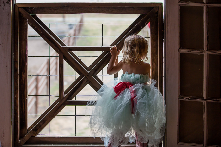 cute flower girl peeking out of the window