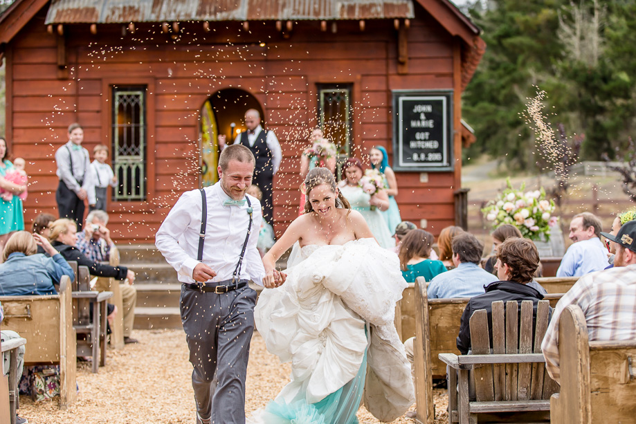 bride and groom running down the aisle as wild oats were thrown at them as blessings