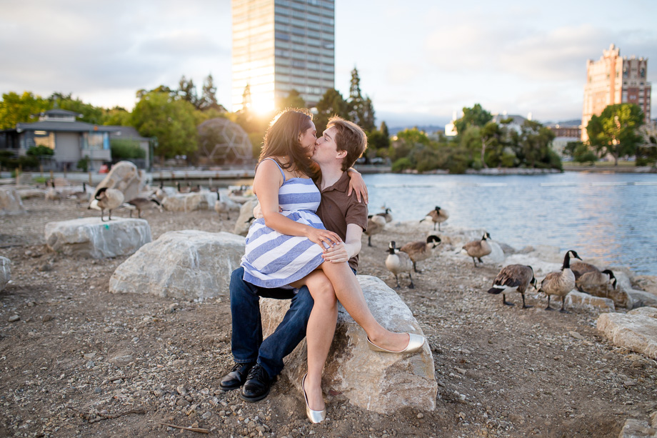 romantic sunset engagement photo by Lake Merritt with friendly canada geese in the background - Bay Area engagement and wedding photographer