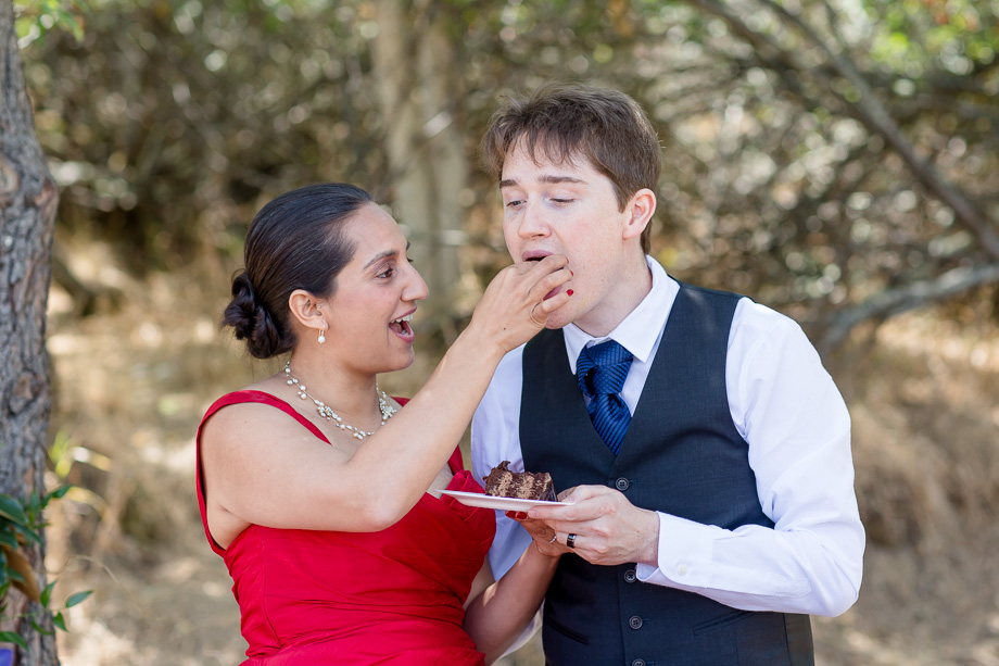 bride feeding the groom a piece of wedding cake