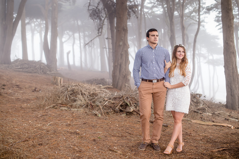 couple in foggy woods looking off into the distance