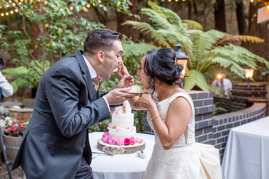 bride and groom feeding each other cake without smashing it