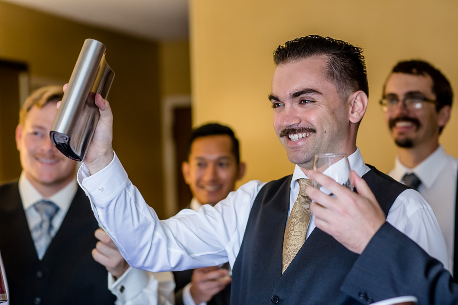 groom holding a giant flask