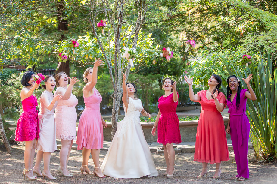 bride and bridesmaids throwing bouquets up in the air