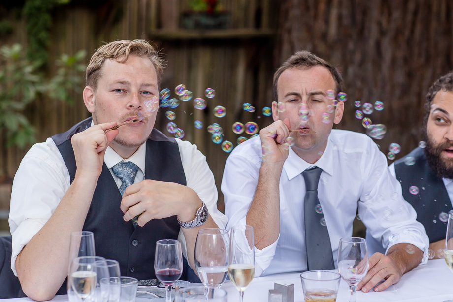groomsmen blowing bubbles