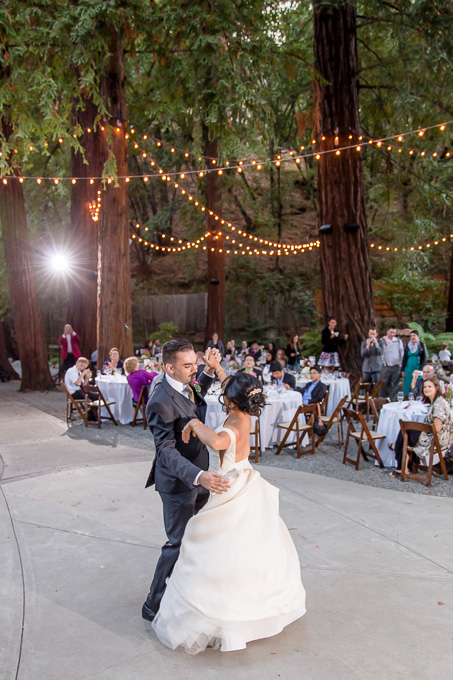 first dance in the redwoods under string lighting