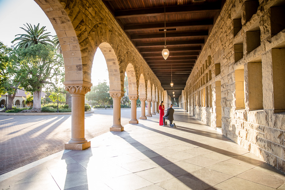 romantic stanford university campus surprise marriage proposal with a stunning view of the walkway and arches