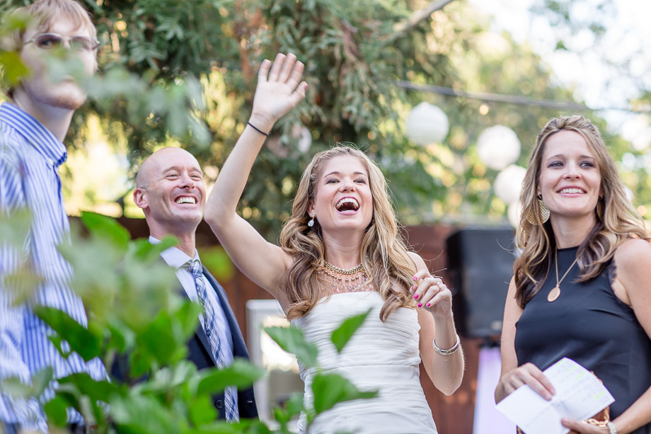 bride and groom waving at guests