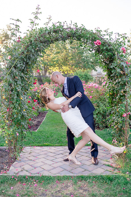 cute photo of the bride and groom in front of the wedding rose arch - san jose rose garden