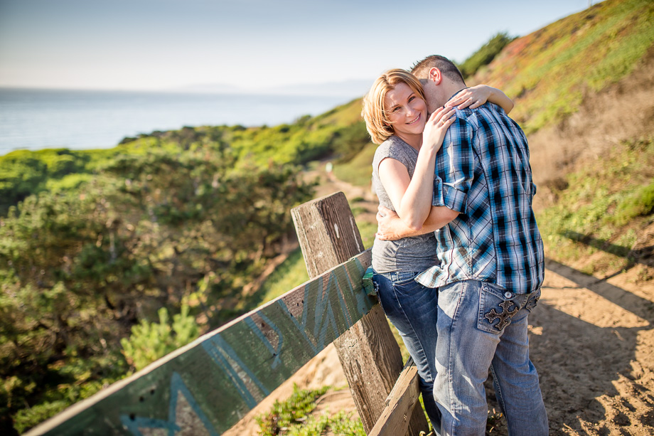 engagement photo by the pacific ocean with a rustic setting