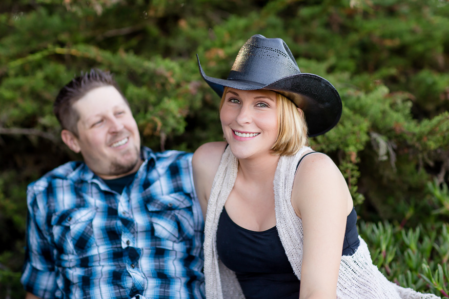 engagement picture with a cowboy hat in the woods