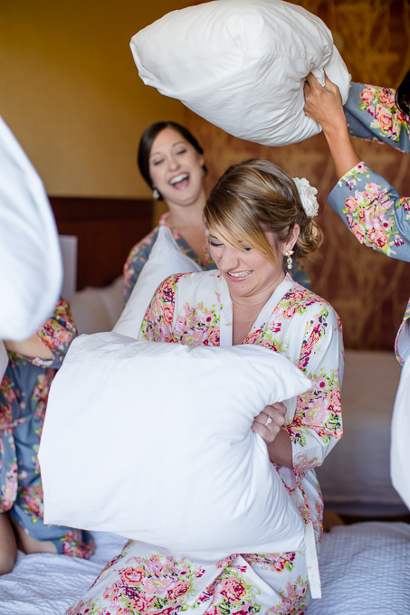 cute pillow fight between bride and bridesmaids