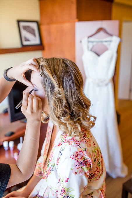 bridesmaid getting makeup touchups done