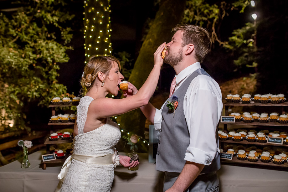 bride smashing cupcake into groom's face